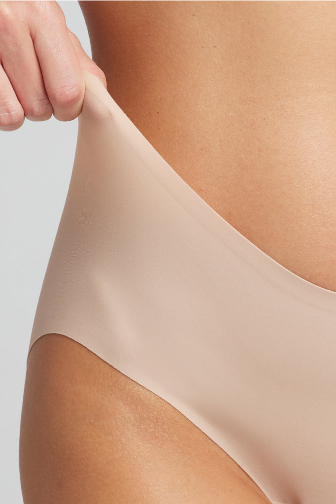 Buff boyshort underwear fabric and leg opening detail.