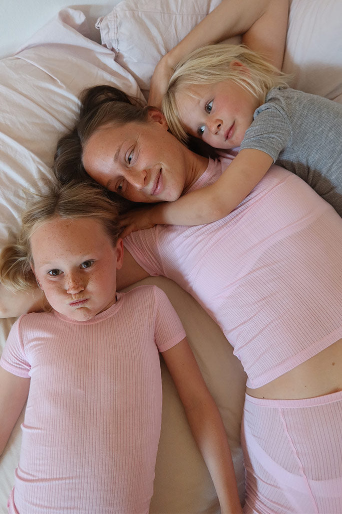 Pink mini tee and short set: round-neck short-sleeve top with matching ribbed shorts