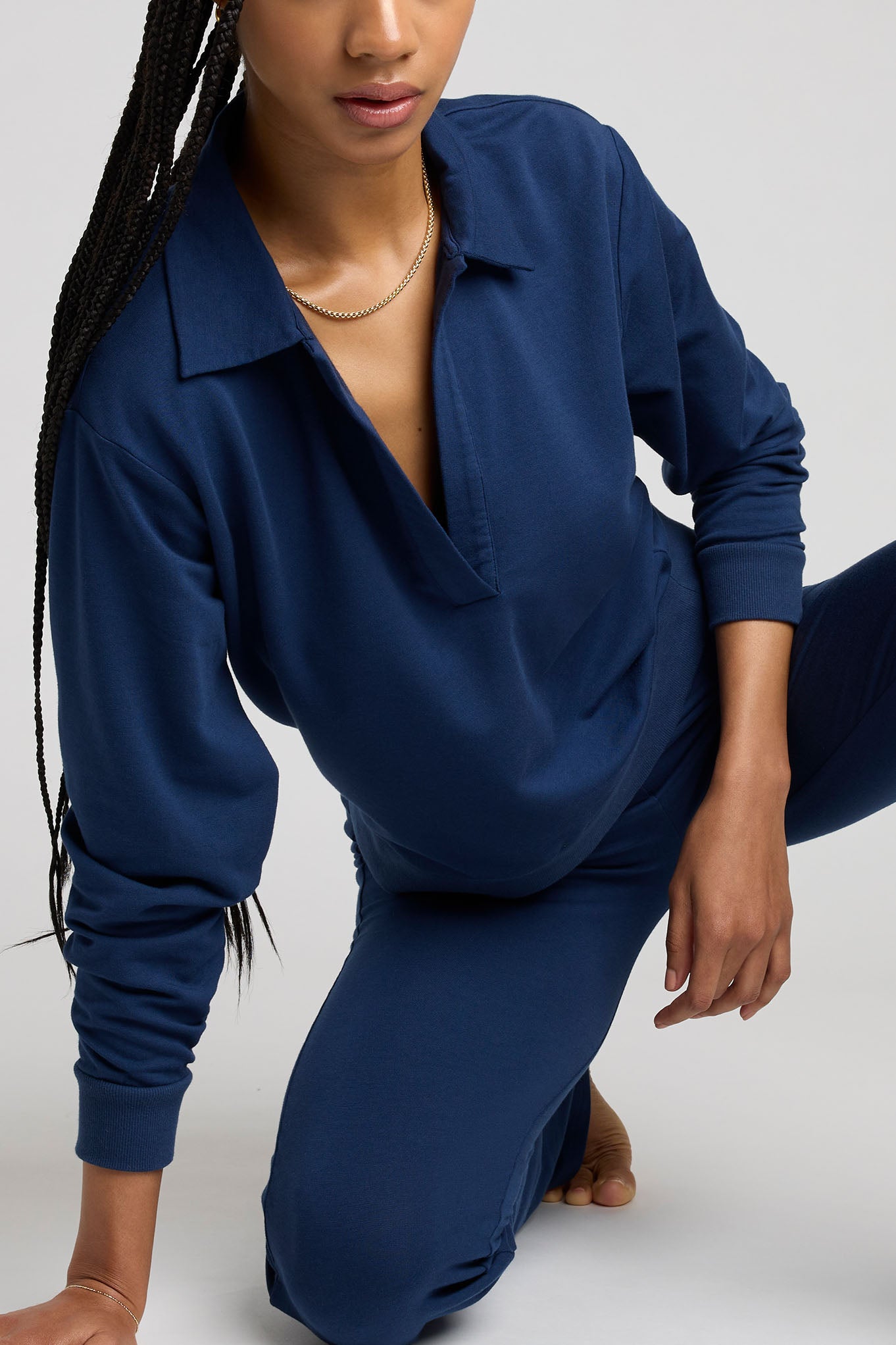 Navy collared pullover top with half-button placket and long sleeves