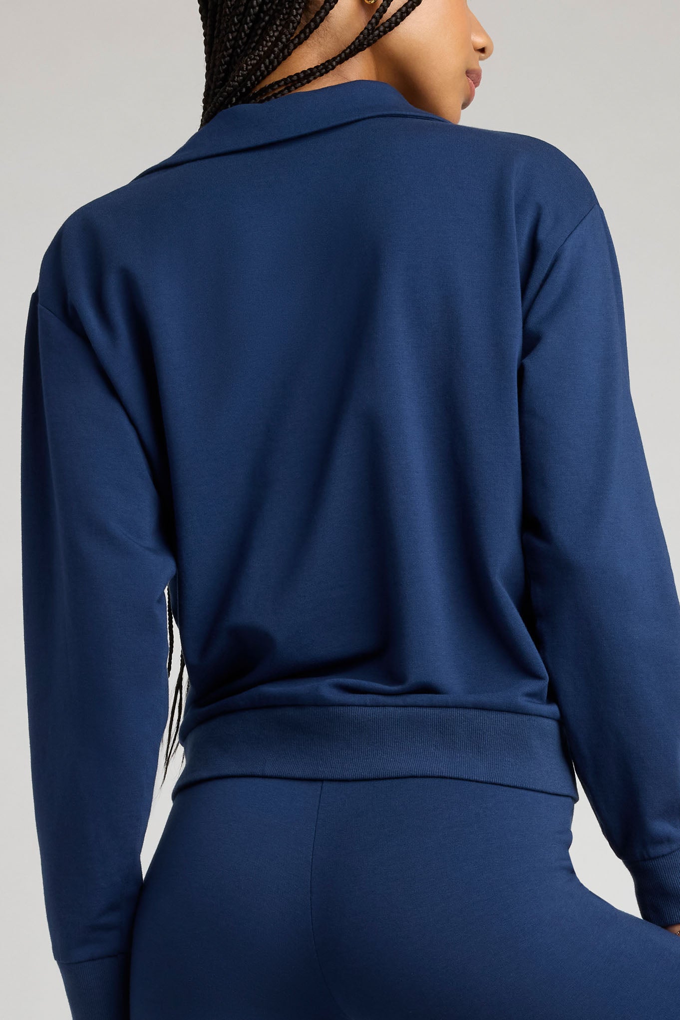 Navy long-sleeve collared pullover, back view, relaxed straight hem