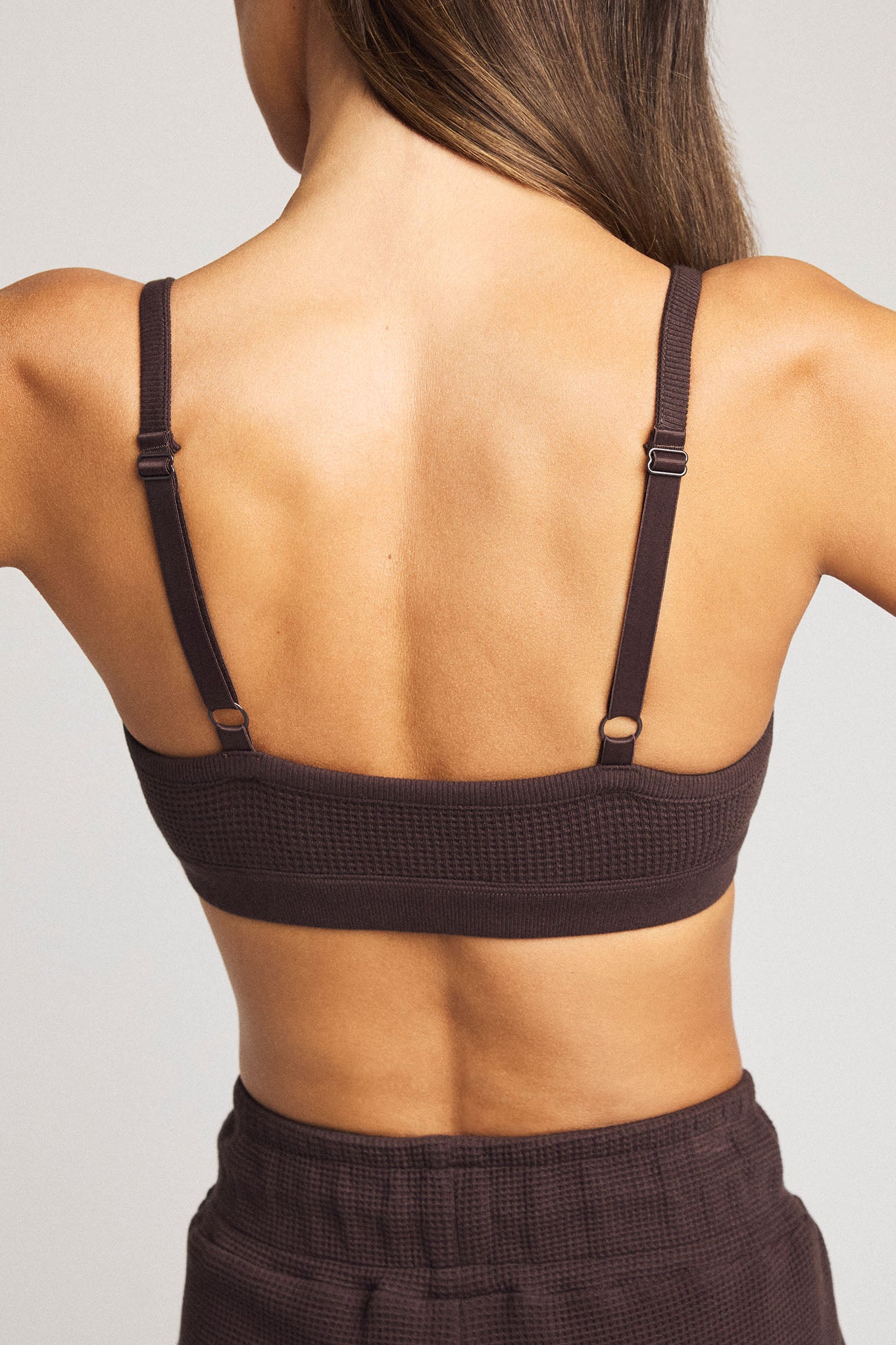 Dark brown waffle-knit bralette with racerback straps and open back