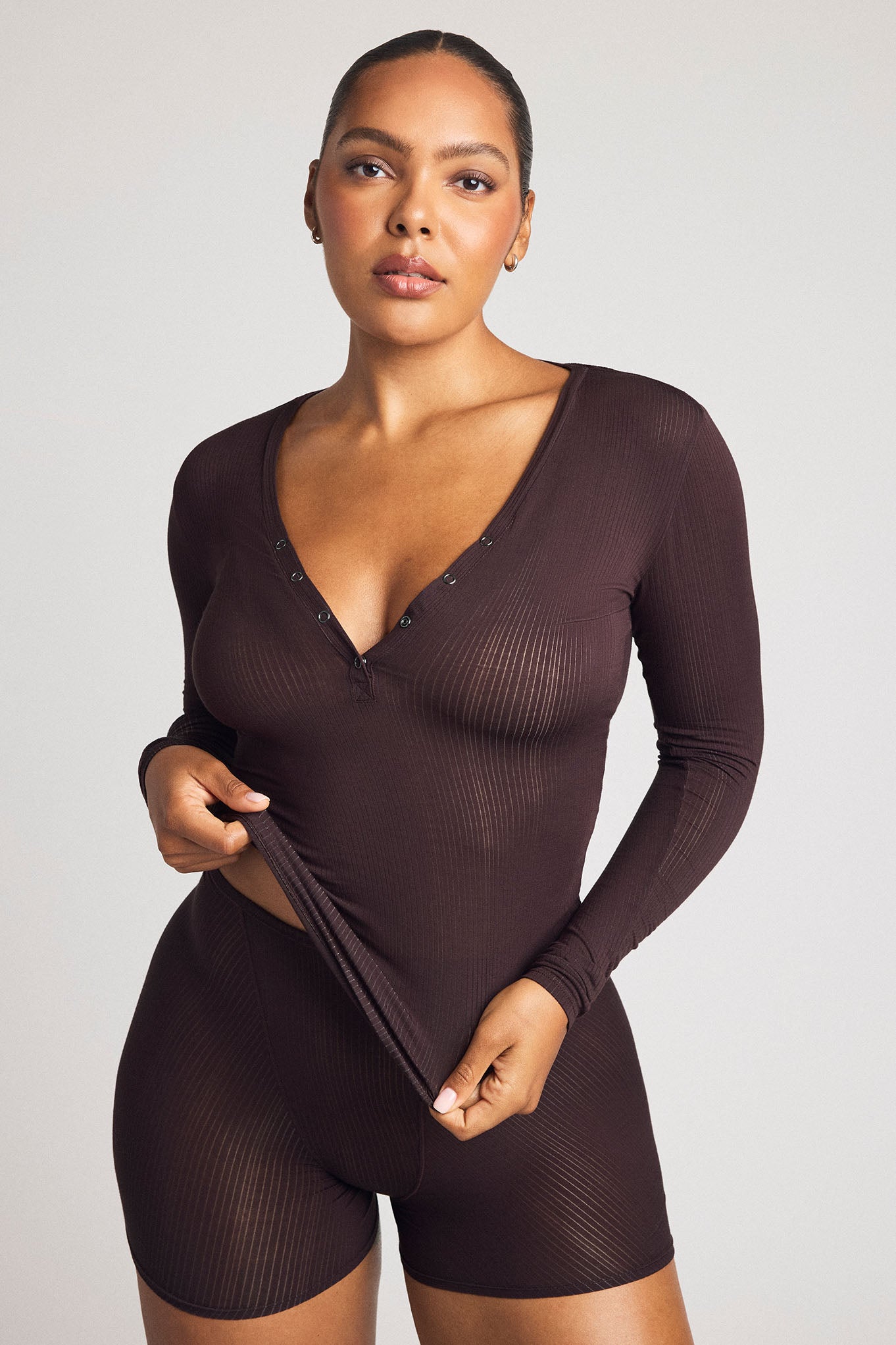 Long-sleeve ribbed henley romper in dark brown with button-front V-neck and shorts