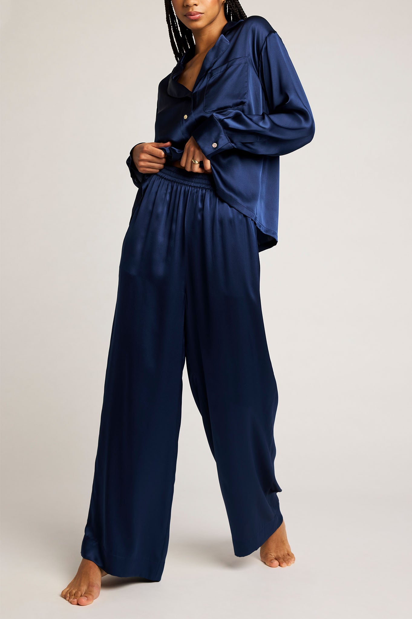 Navy button-up shirt with long sleeves and open V-neck, worn with loose pants