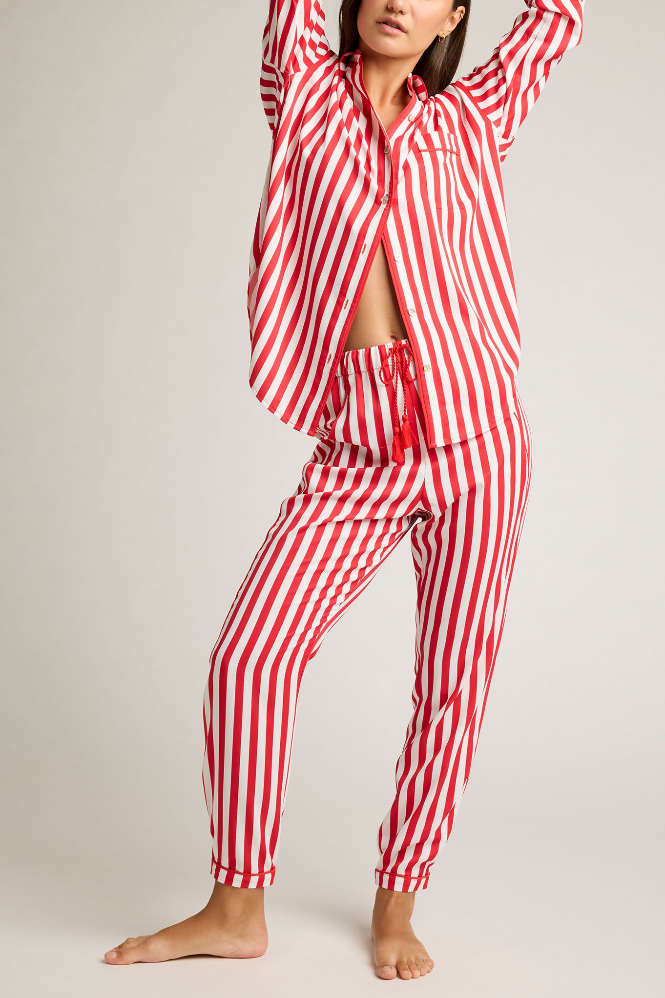 Red and white striped jogger pants with elastic ankle cuffs
