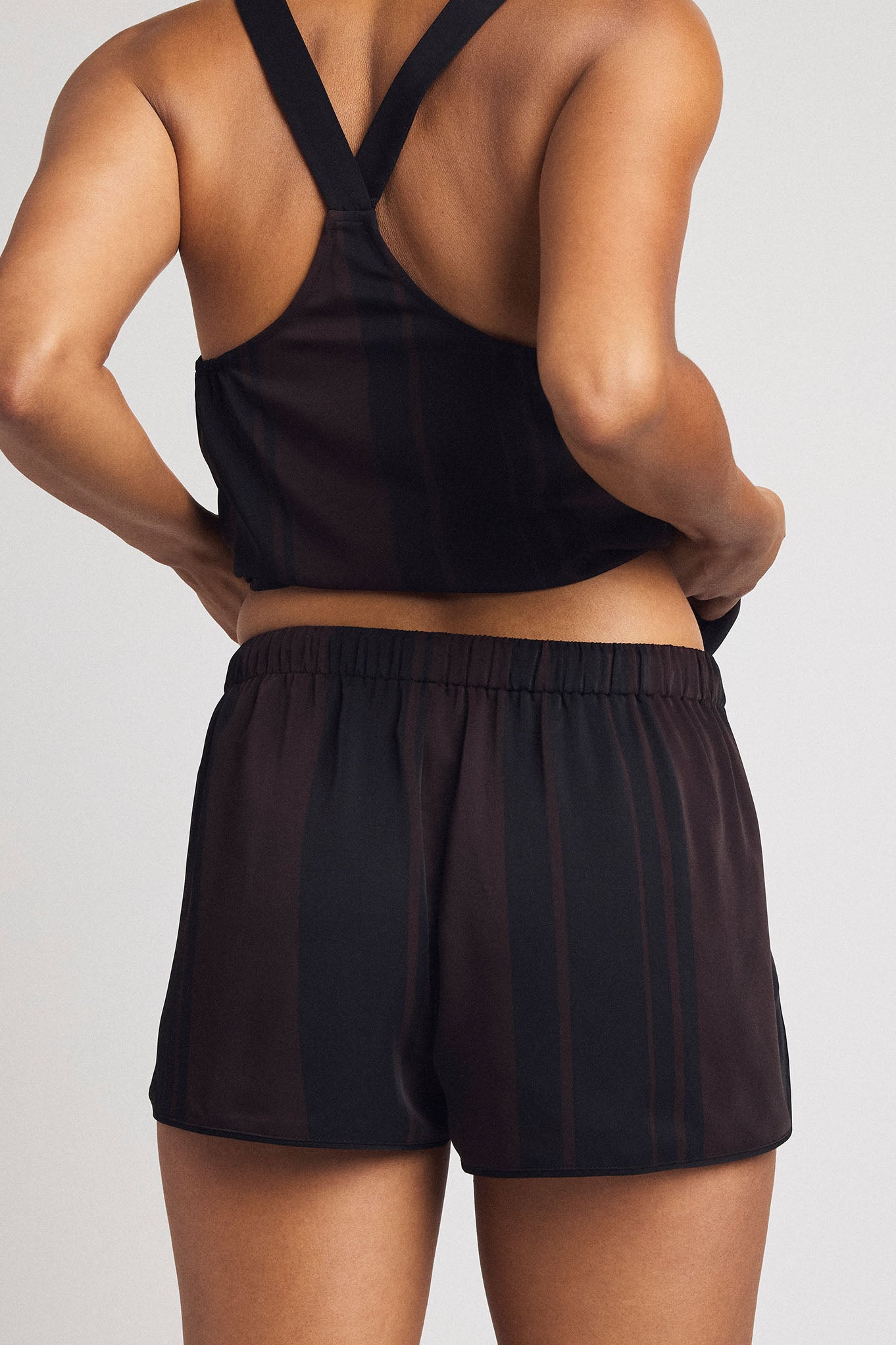 Dark shorts with elastic waistband, relaxed fit, and visible side seam detail